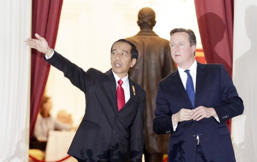 Indonesia's President Joko Widodo greets UK Prime Minister Cameron.